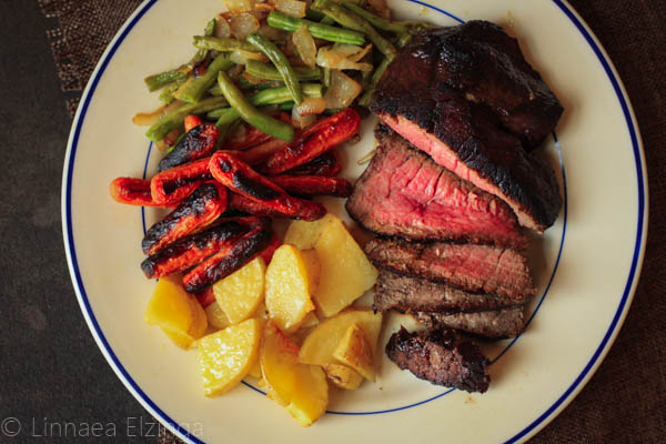 Top sirloin steak with roasted potatoes and carrots and sauteed green beans. 