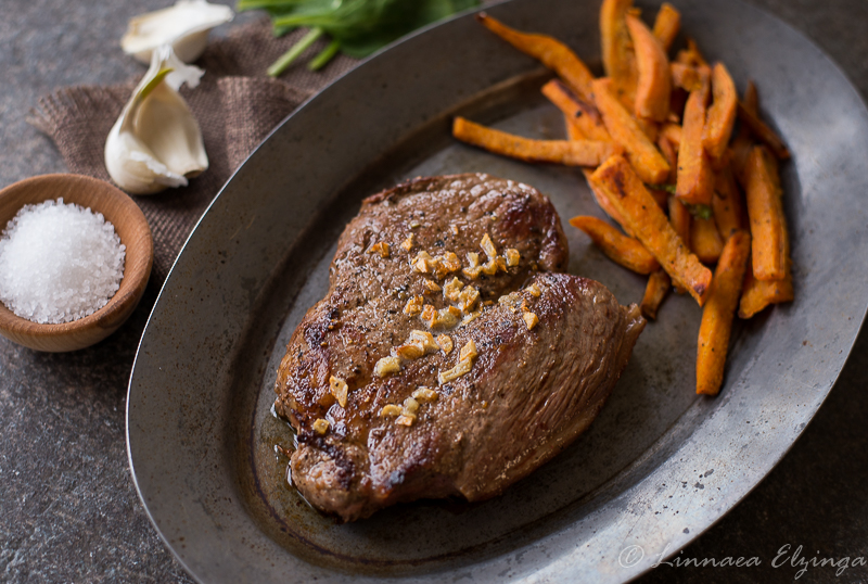 Grass fed organic beef garlic top sirloin steak with sweet potato fries.