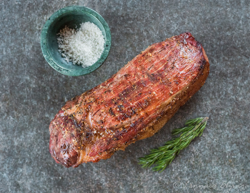 Whole eye of round with sea salt and rosemary garnish. 