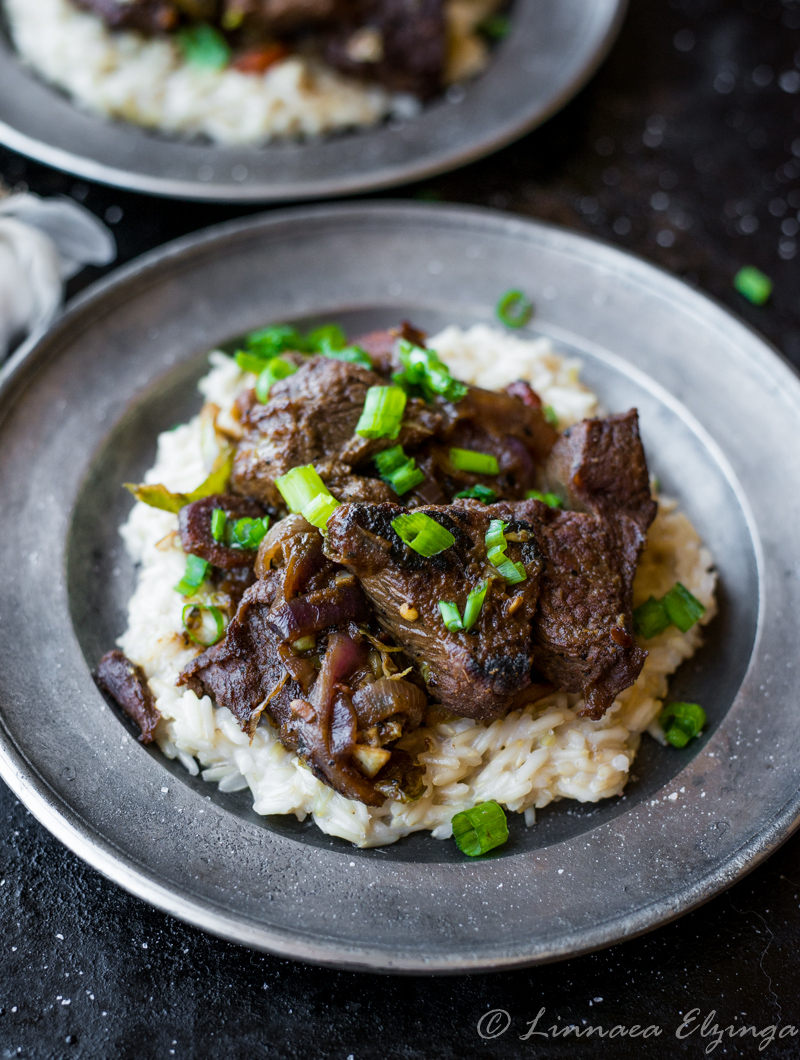 Closeup of Asian-inspired stew beef stir fry over rice.