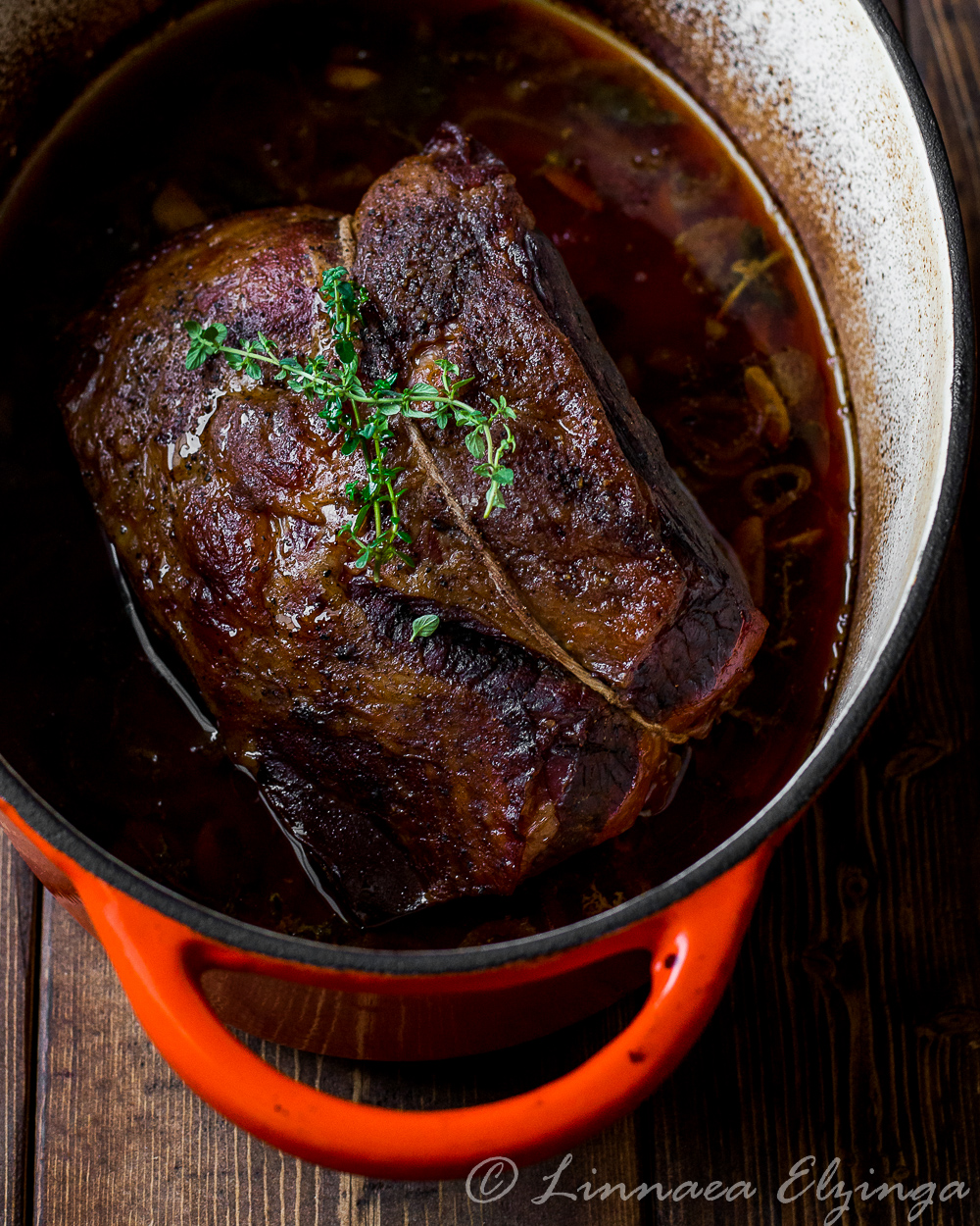 Close up of garlic herb beef roast in the roaster. 