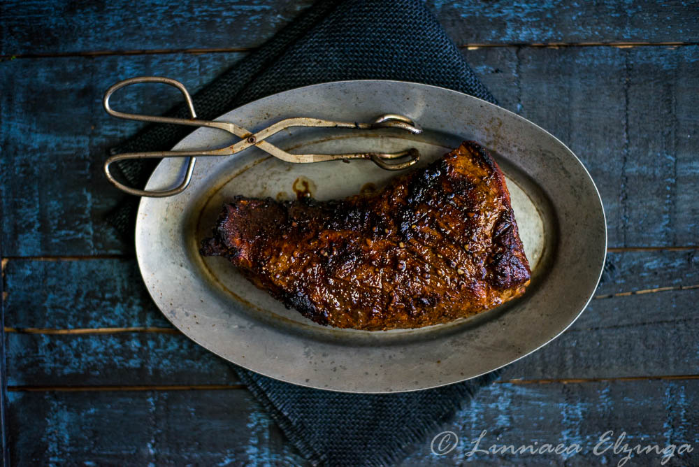 Whole tri tip roast with rub, cooked on the grill. 