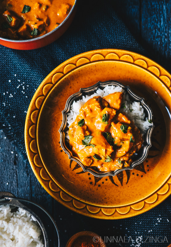 Pastured Poultry Chicken Tikka Masala served over rice on an orange plate. 