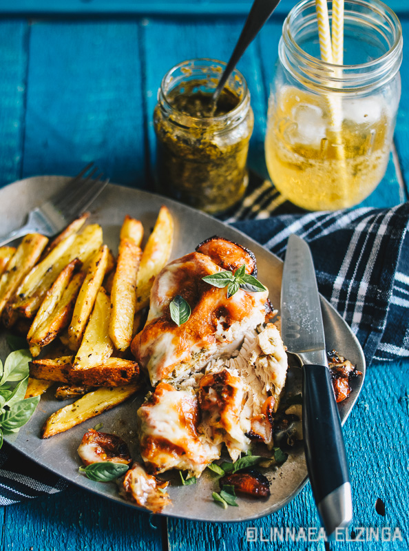 Tender Italian pesto chicken breast with a side of potato fries. 