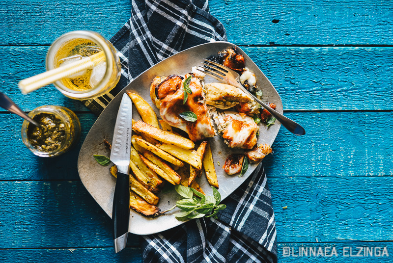 Italian chicken breast dinner, with pesto and potato fries. 