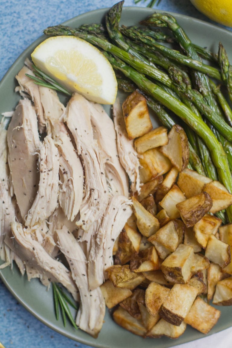 Lemon rosemary whole chicken with asparagus and roast potatoes on the side. 