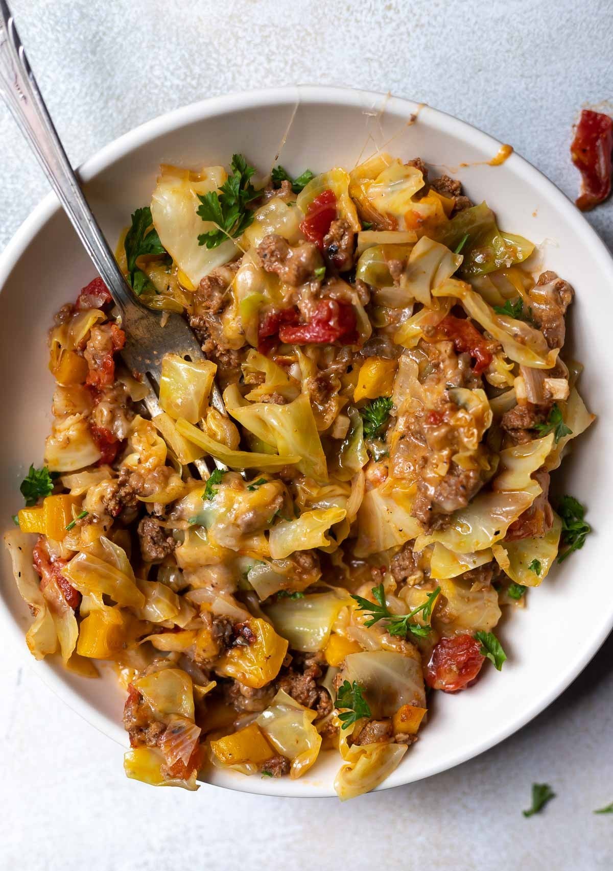 Unstuffed cabbage casserole close up with fork. 